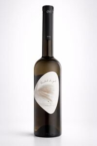 Fotografía de producto de una botella de vino blanco con etiqueta minimalista. Botella de vino blanco con etiqueta blanca sobre fondo claro